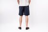 Person wearing navy shorts on a white background