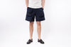 Person wearing navy shorts on a white background
