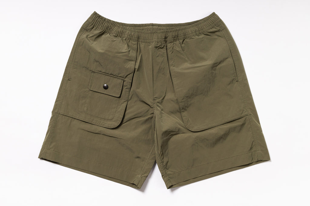 Olive green shorts with a pocket on a white background
