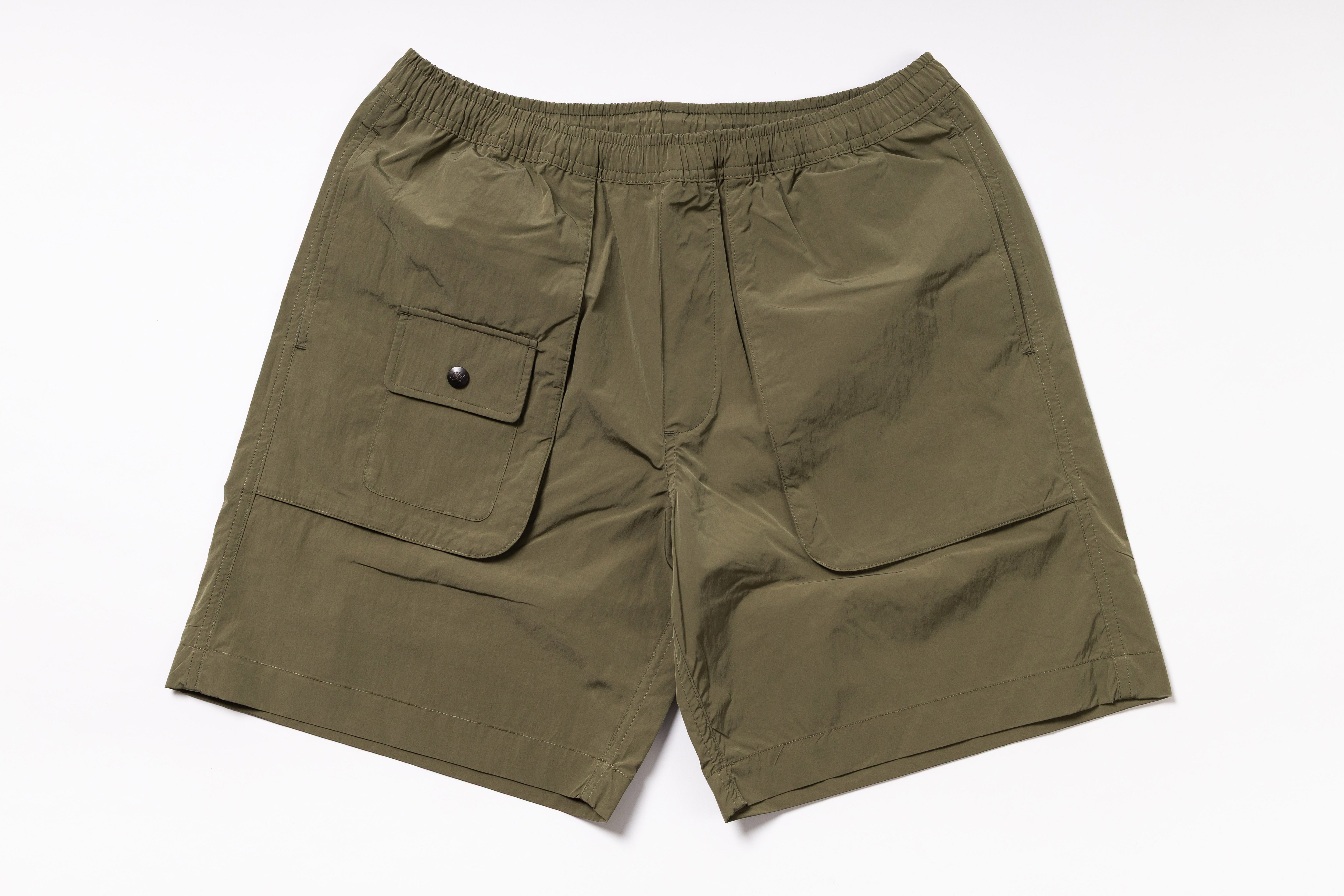 Olive green shorts with a pocket on a white background