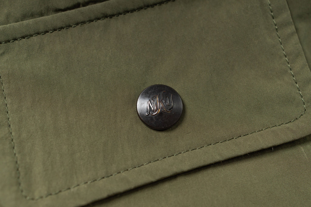 Close-up of a button on a green fabric surface