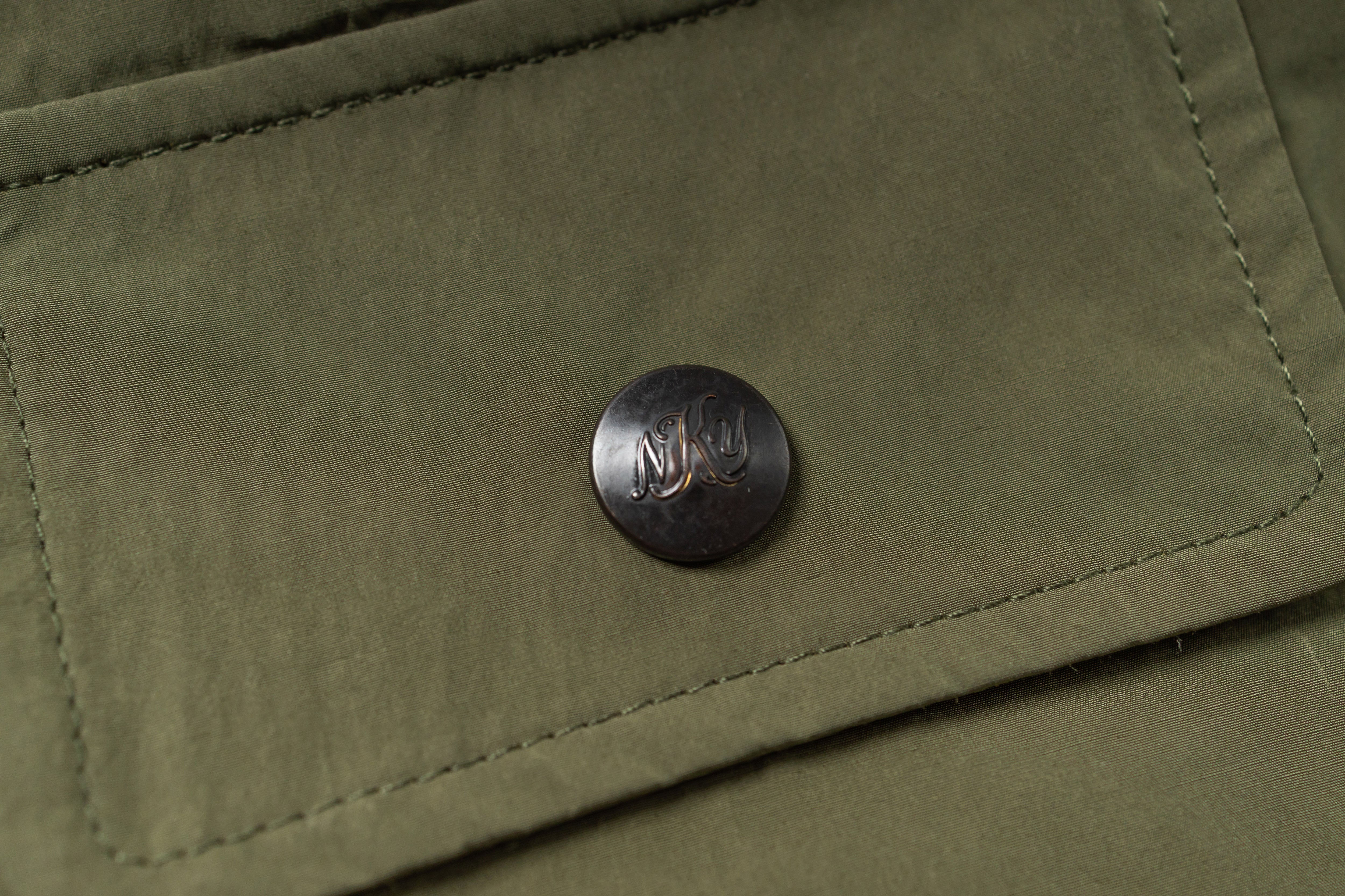 Close-up of a button on a green fabric surface