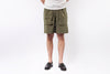 Person wearing olive green cargo shorts on a white background