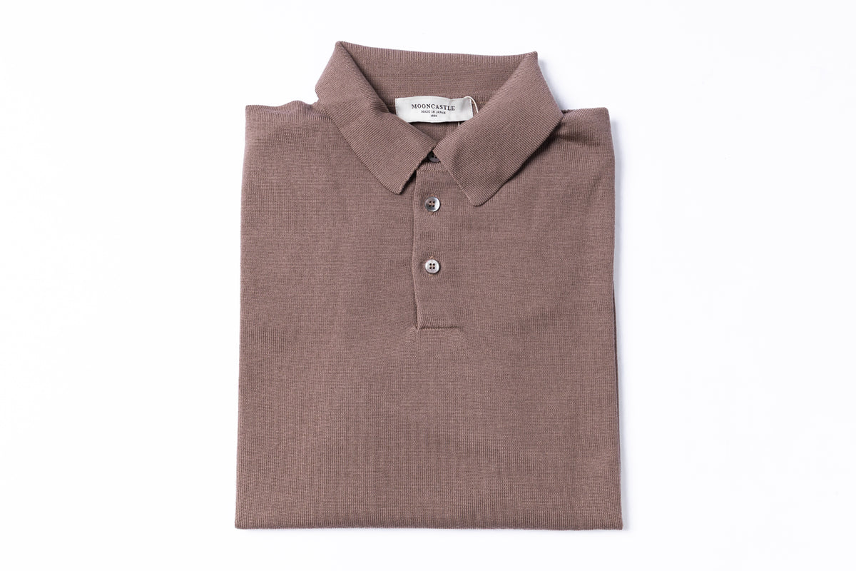 A folded brown polo shirt with a two-button placket, displayed flat against a solid white background.