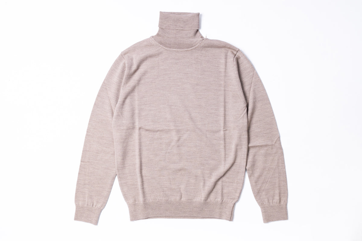 A light beige knit turtleneck sweater shown from the back, laid flat against a clean white background.