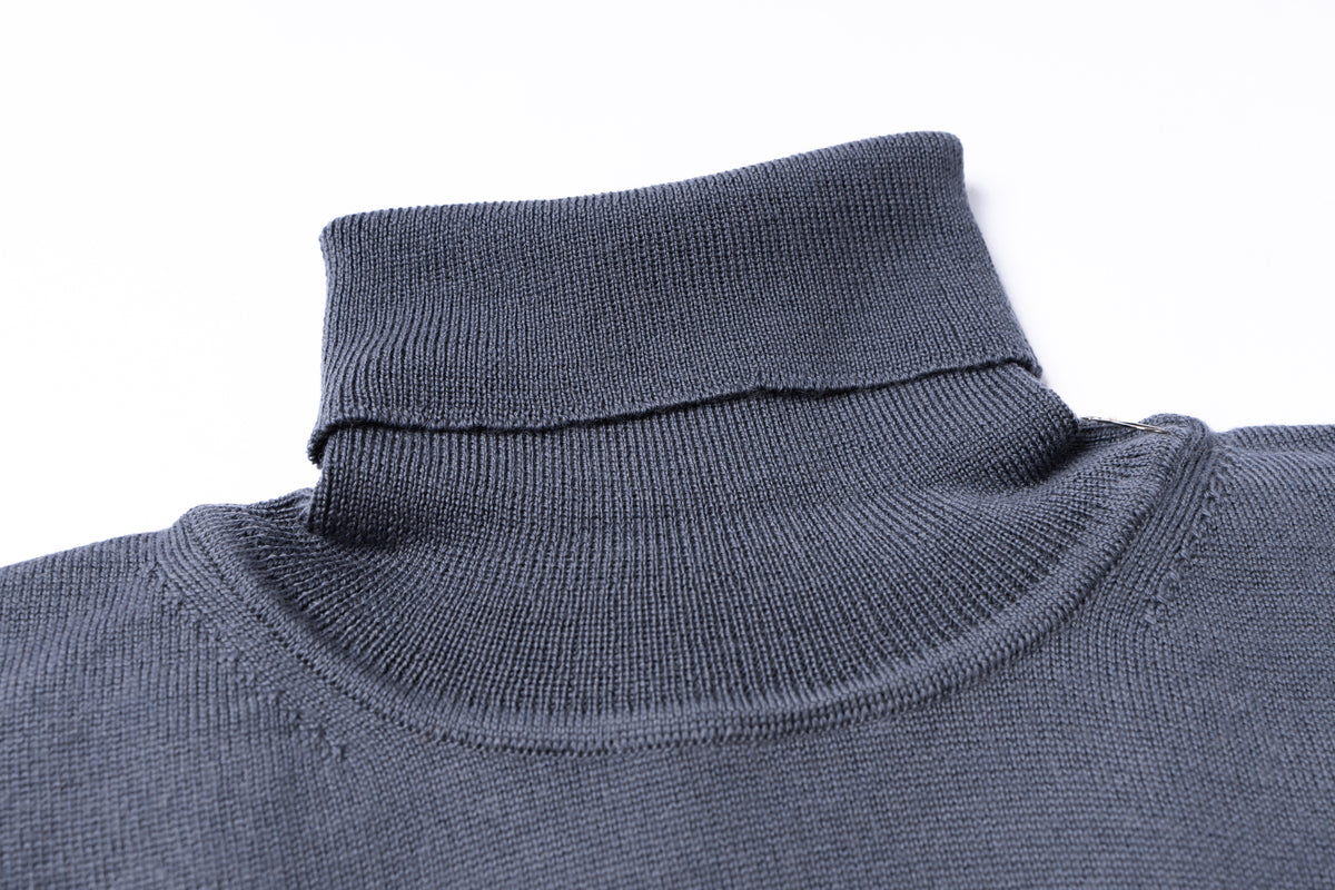 Close-up of a dark gray ribbed knit turtleneck sweater collar on a white background.
