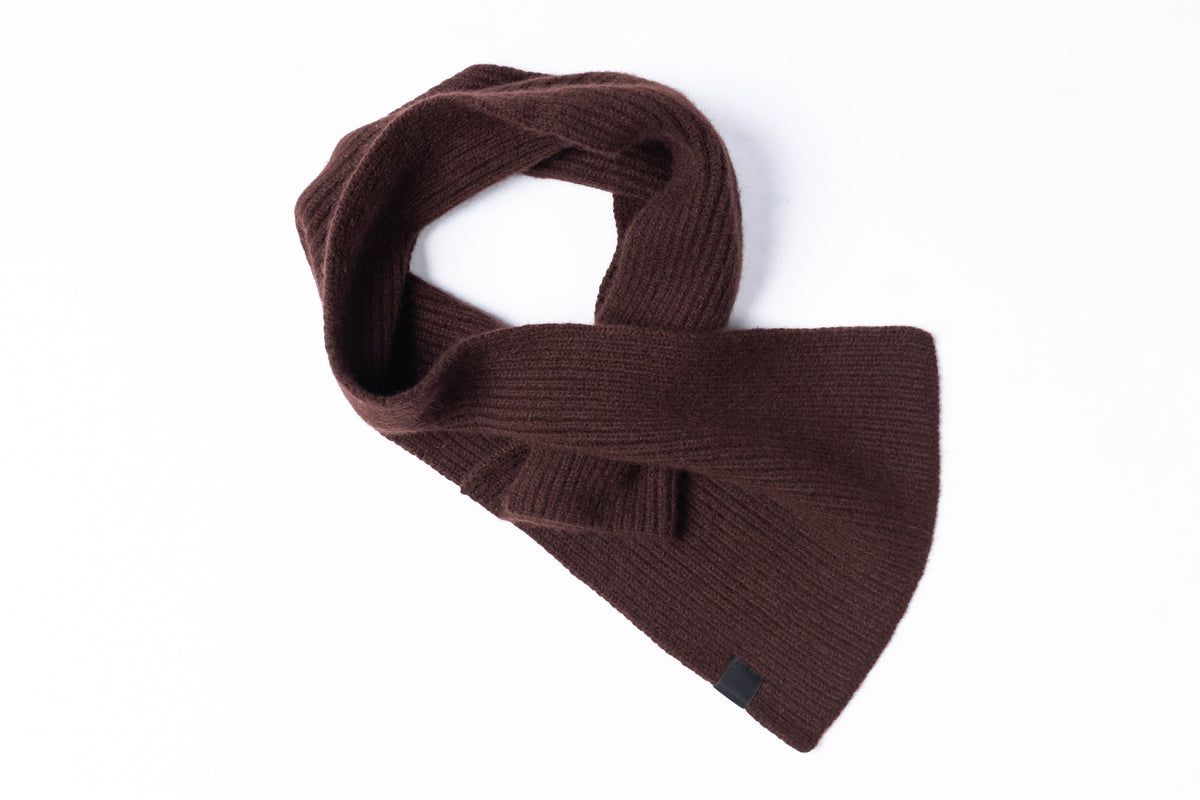 A dark brown ribbed knit neck warmer scarf, styled in a loose loop on a clean white background.