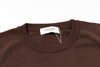 Brown sweater with a brand tag on a white background