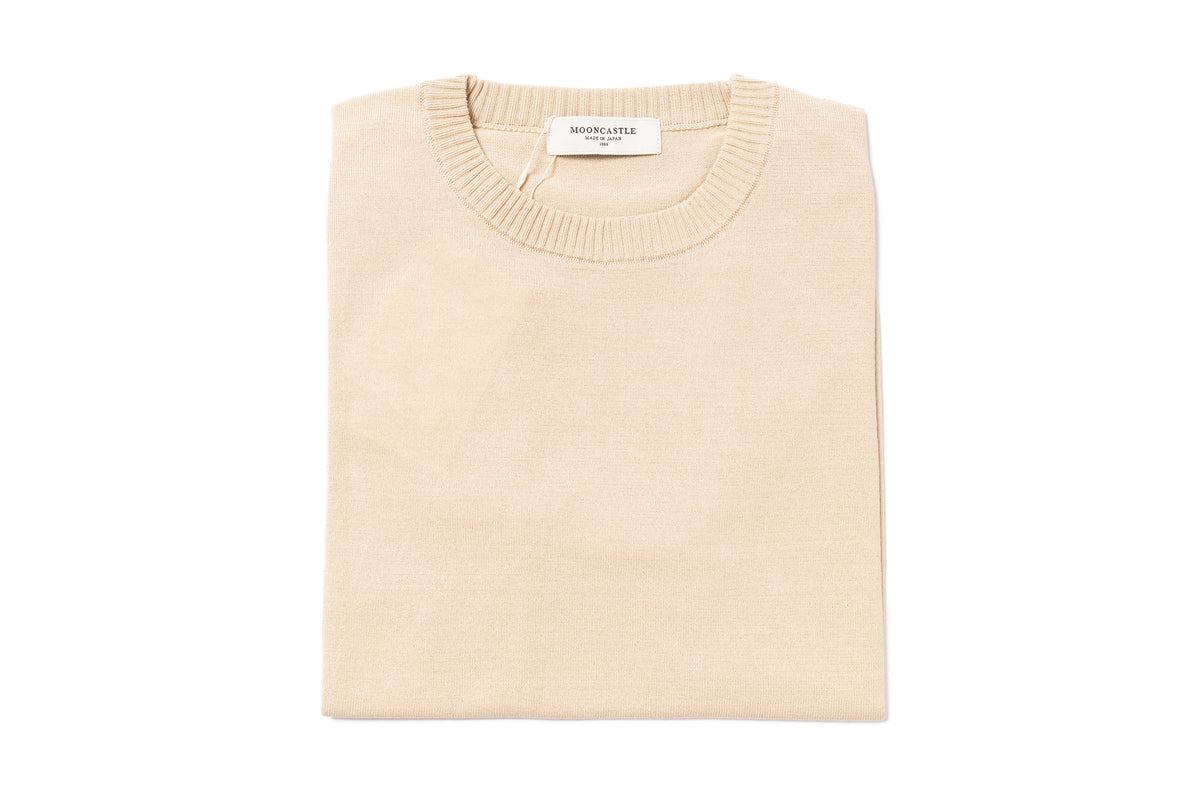 Beige sweater with a brand label on a white background