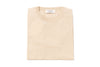 Beige sweater with a brand label on a white background