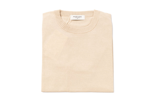 Beige sweater with a brand label on a white background