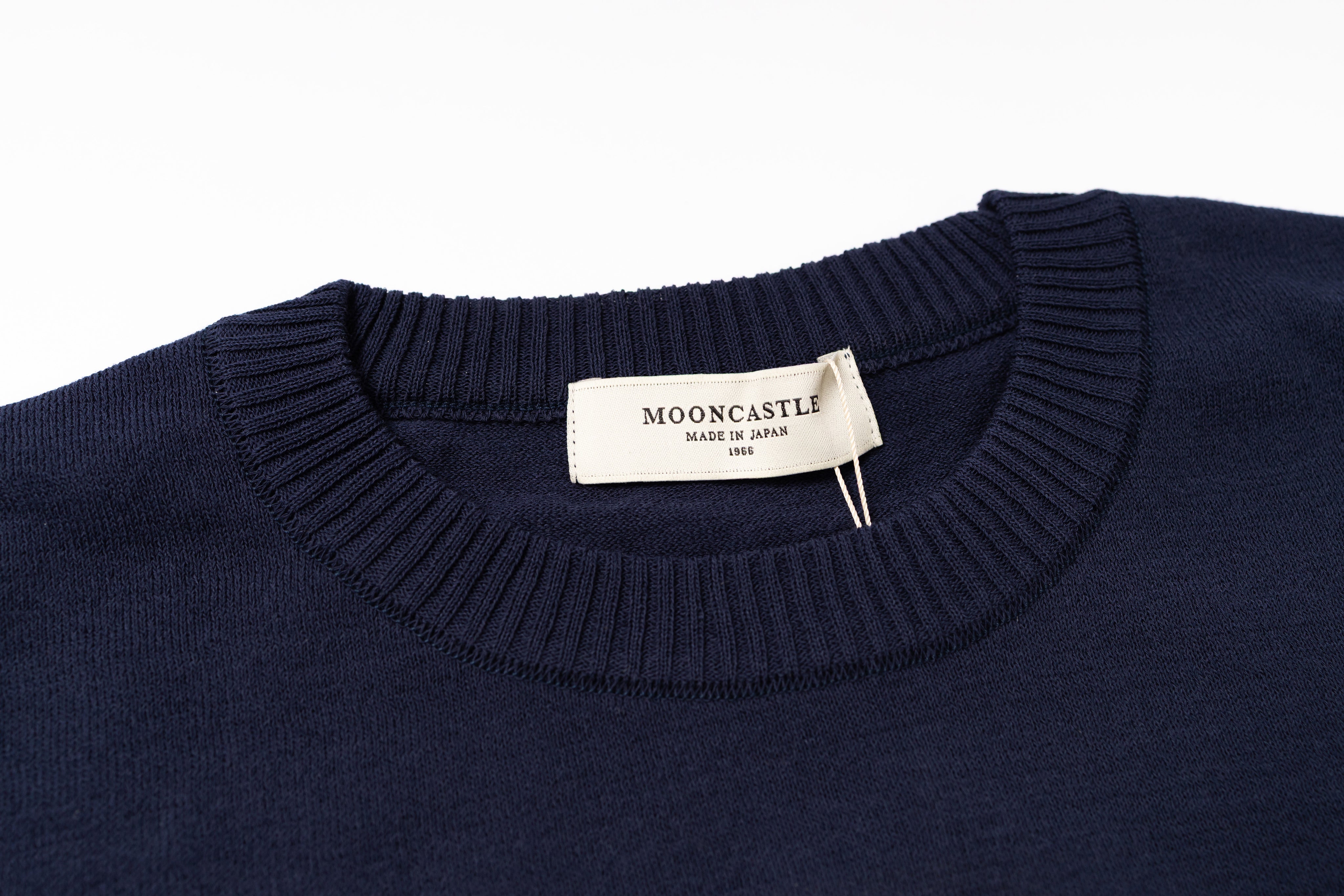 Navy sweater with a visible brand label on a white background