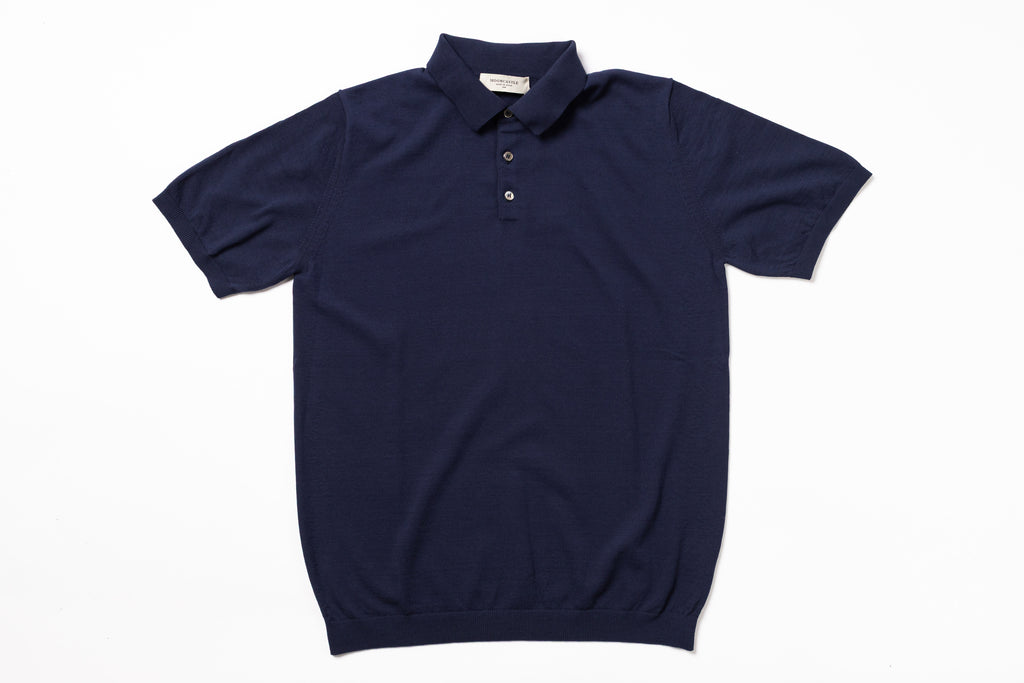 Navy blue polo shirt on a white background