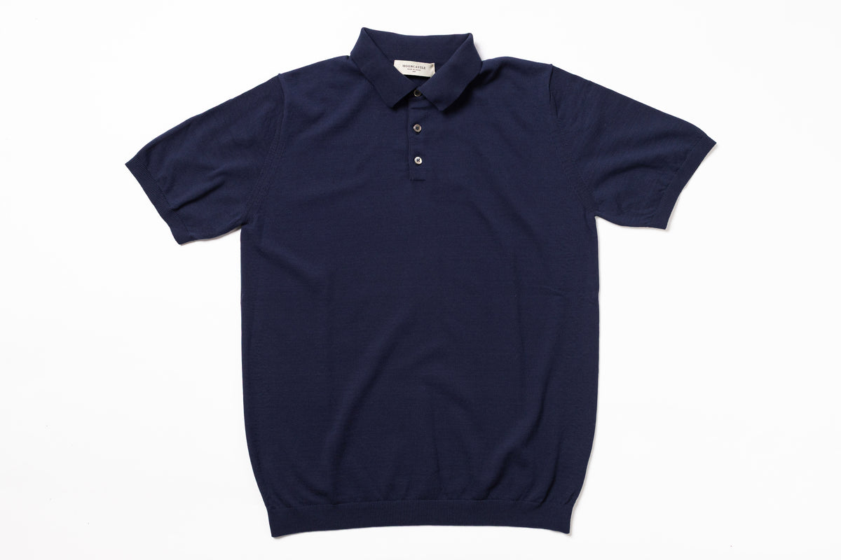 Navy blue polo shirt on a white background