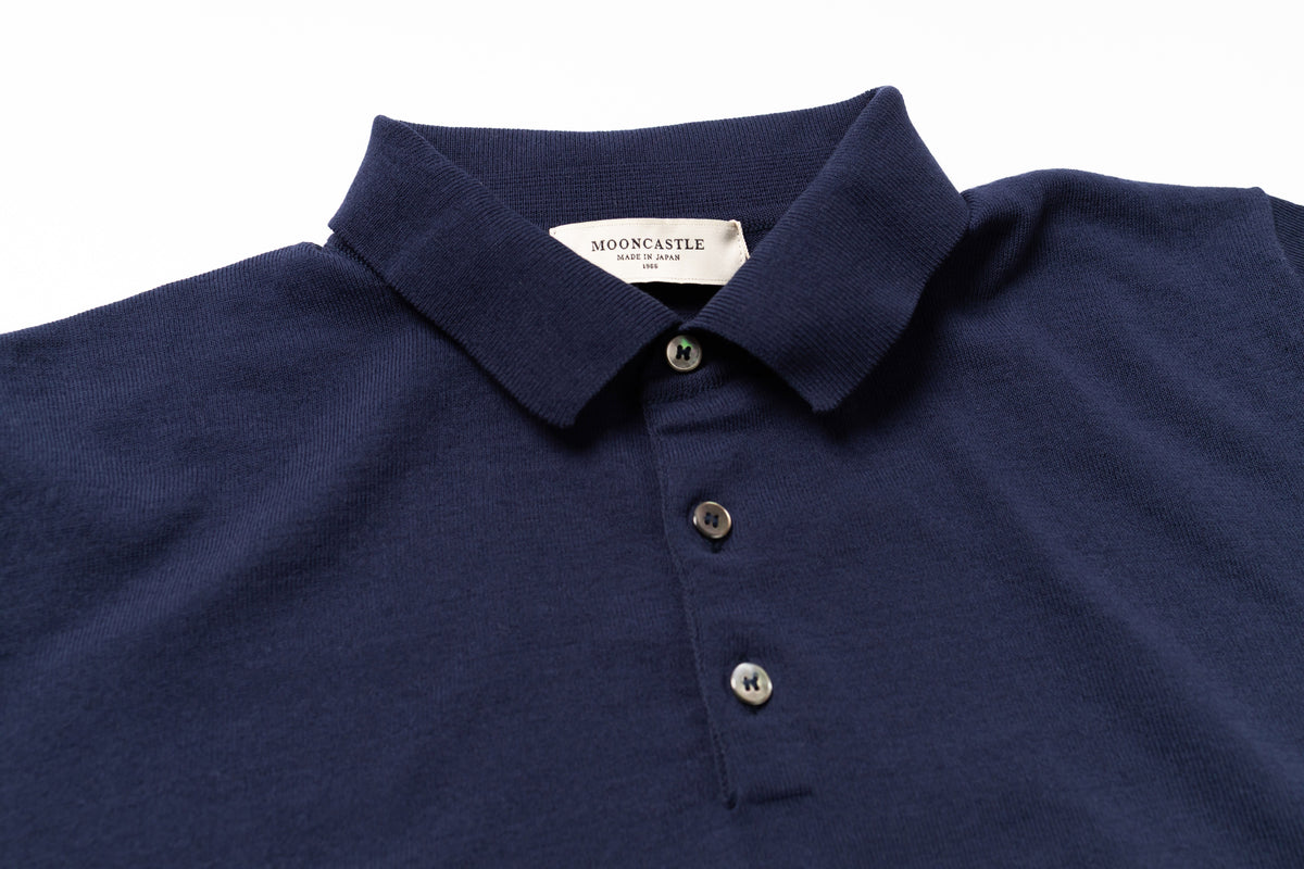 Navy blue polo shirt with a brand label on a white background
