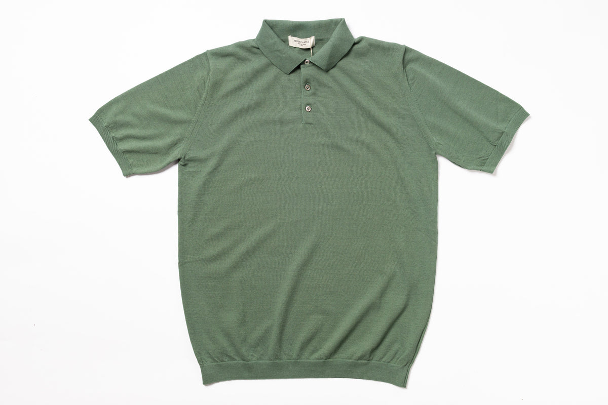 Green polo shirt on a white background