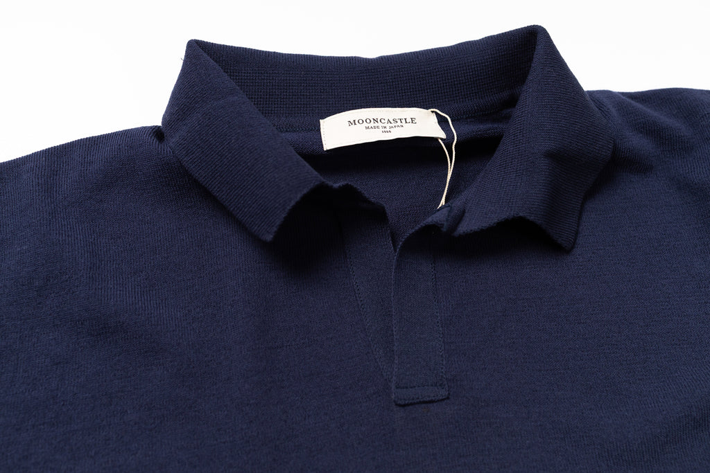 Navy blue polo shirt with a tag on a white background