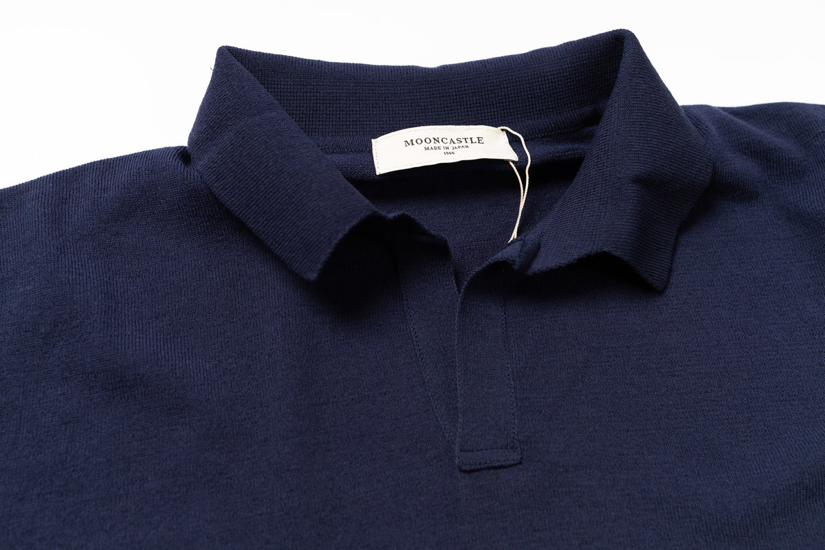 Navy blue polo shirt with a tag on a white background