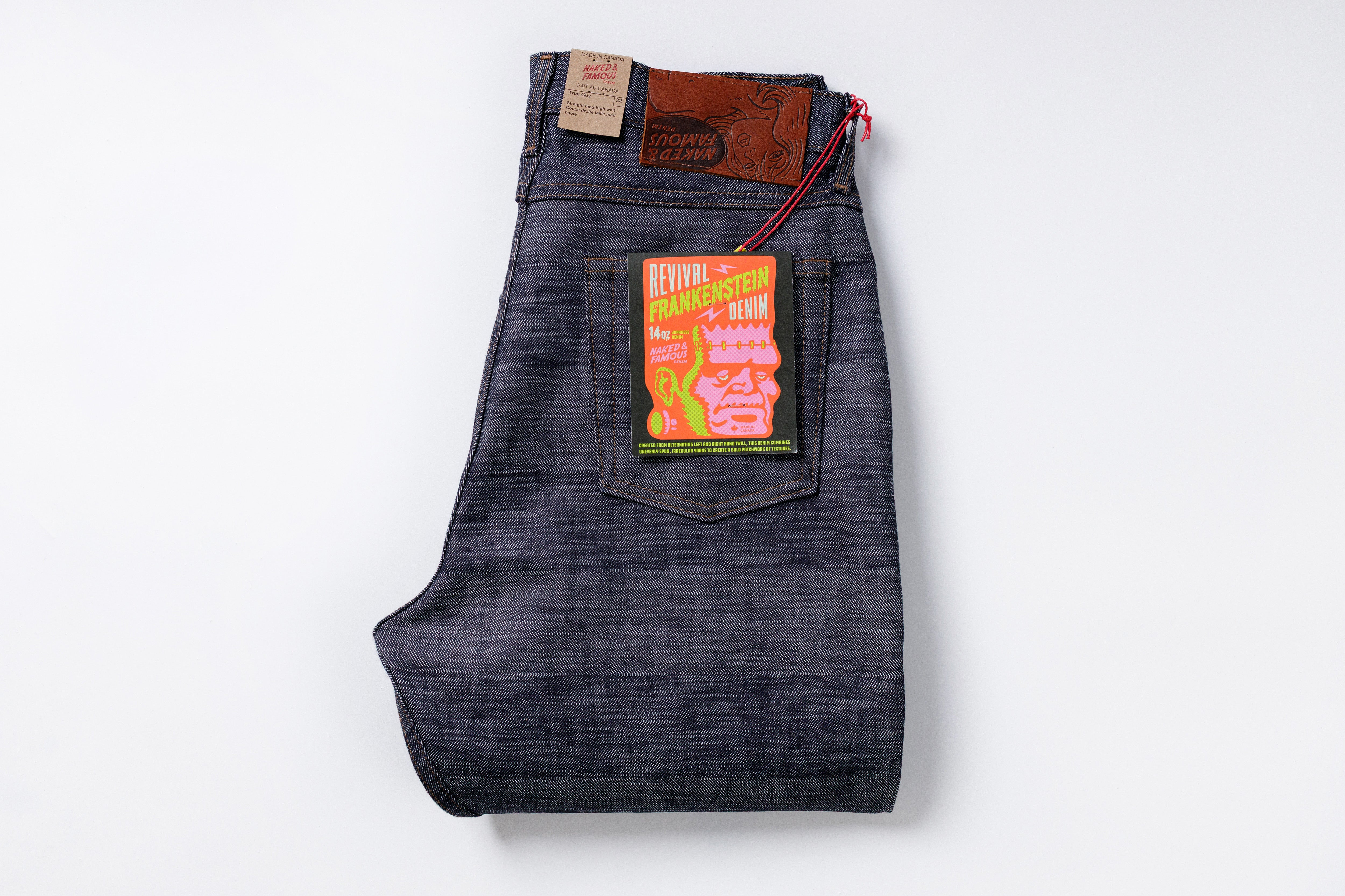 Folded pair of jeans with a brand label on a white background