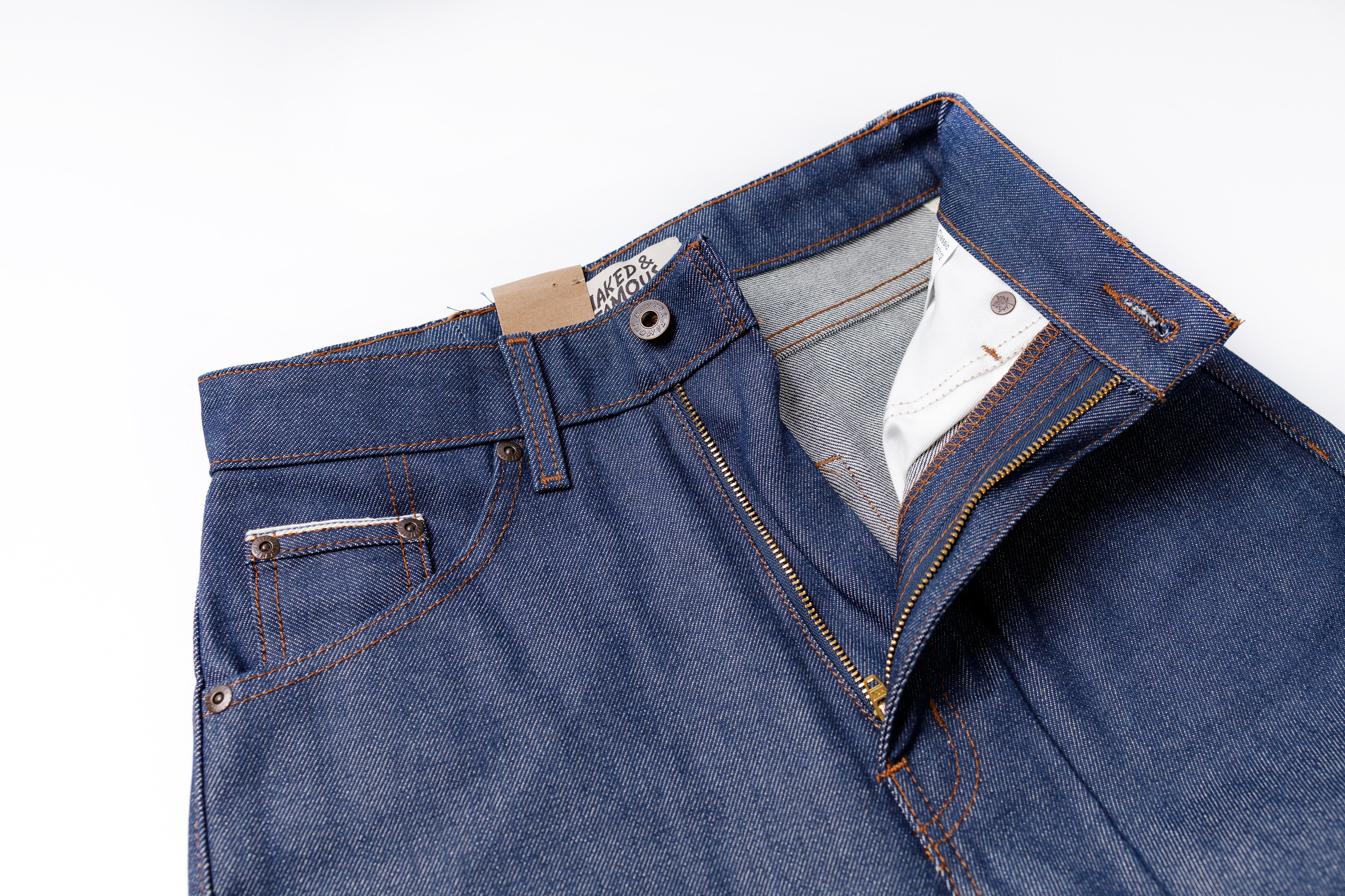 Blue jeans with a brand label on a white background