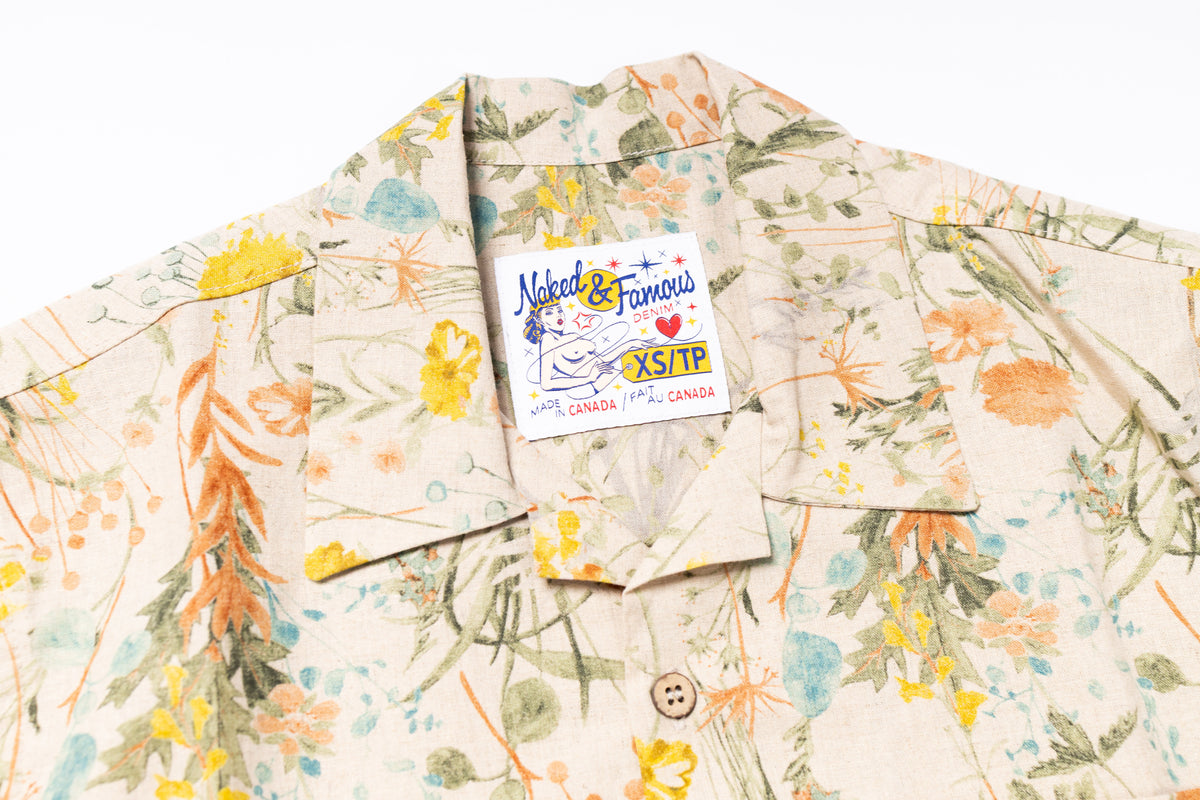 Floral patterned shirt with a brand tag on a white background