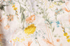 Close-up of floral fabric pattern with various colors on a white background