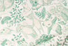 A close-up of a fabric or wallpaper pattern featuring green line-art illustrations of bears, pandas, mushrooms, and leaves on a warm off-white background.