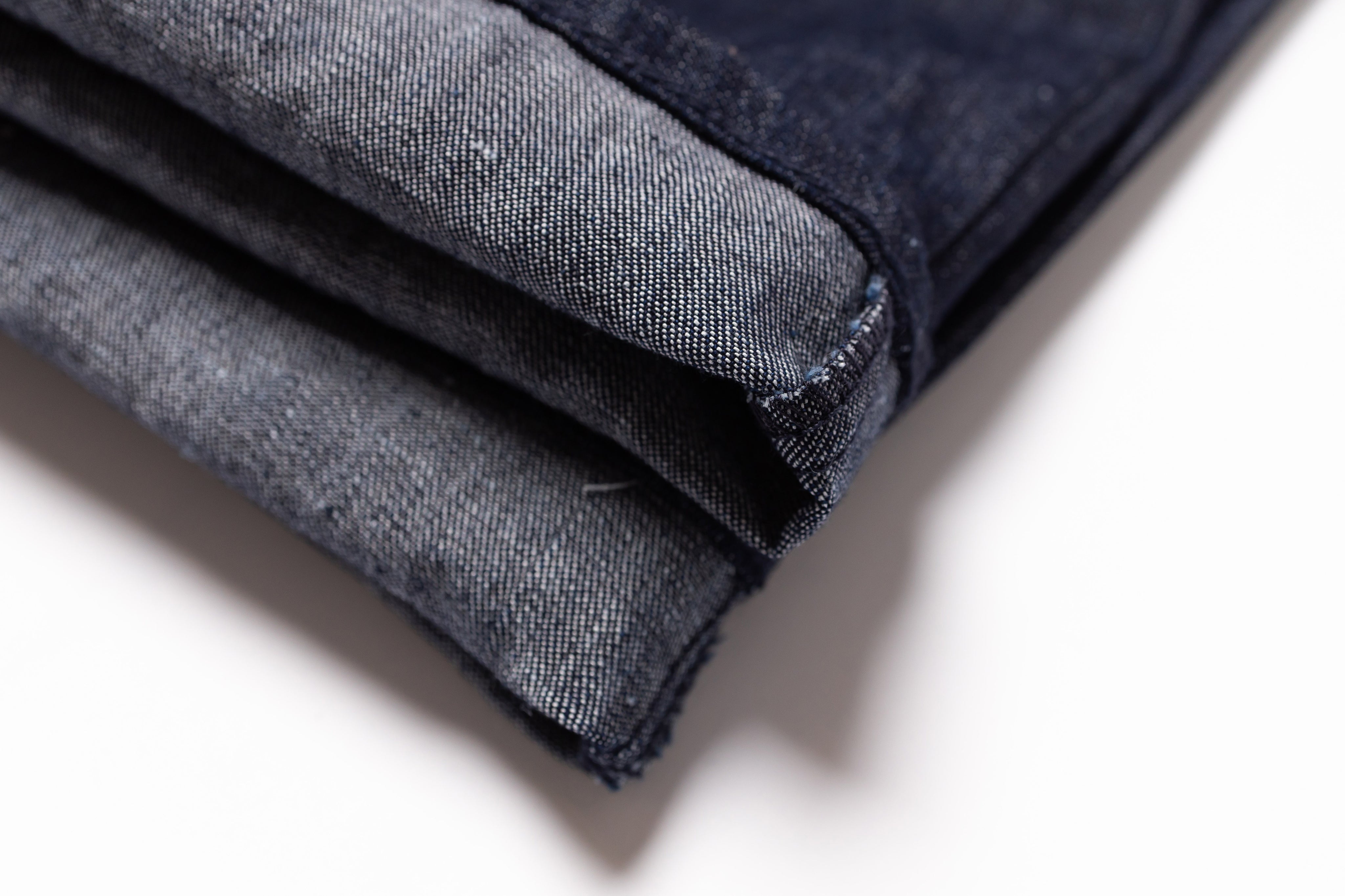 Folded denim fabric on a white background