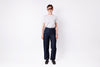 Person wearing dark blue jeans and a white shirt on a white background