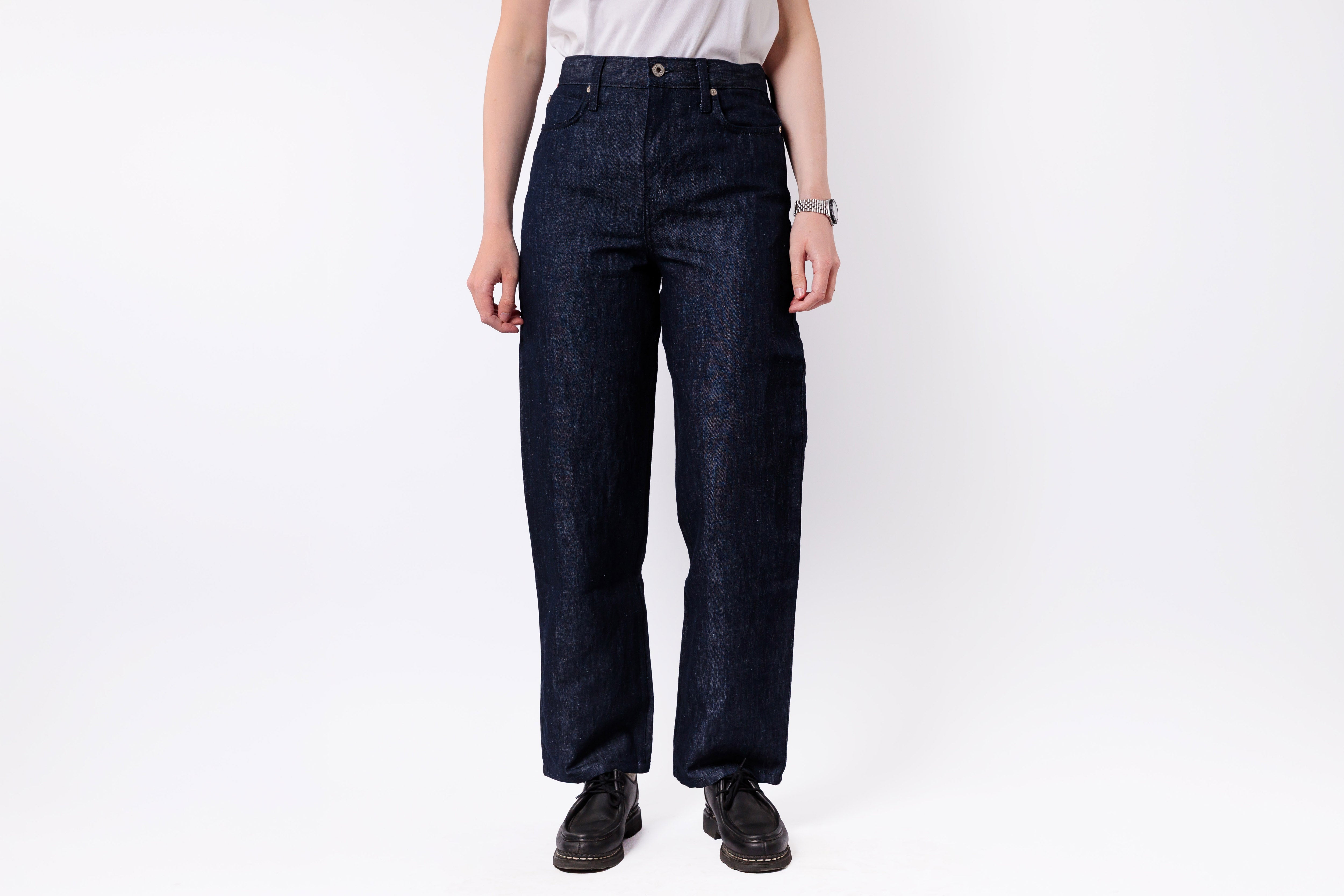 Person wearing dark blue jeans on a white background