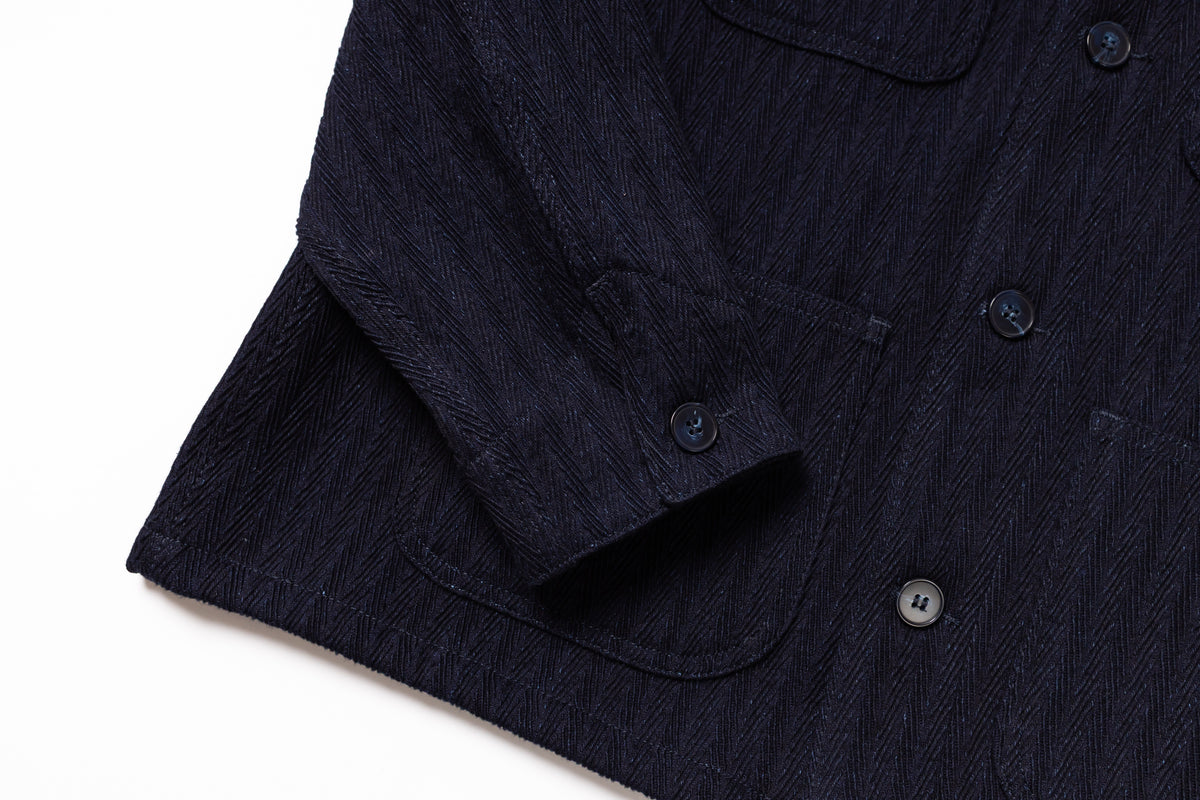 Close-up of a dark blue shirt with buttons on a white background
