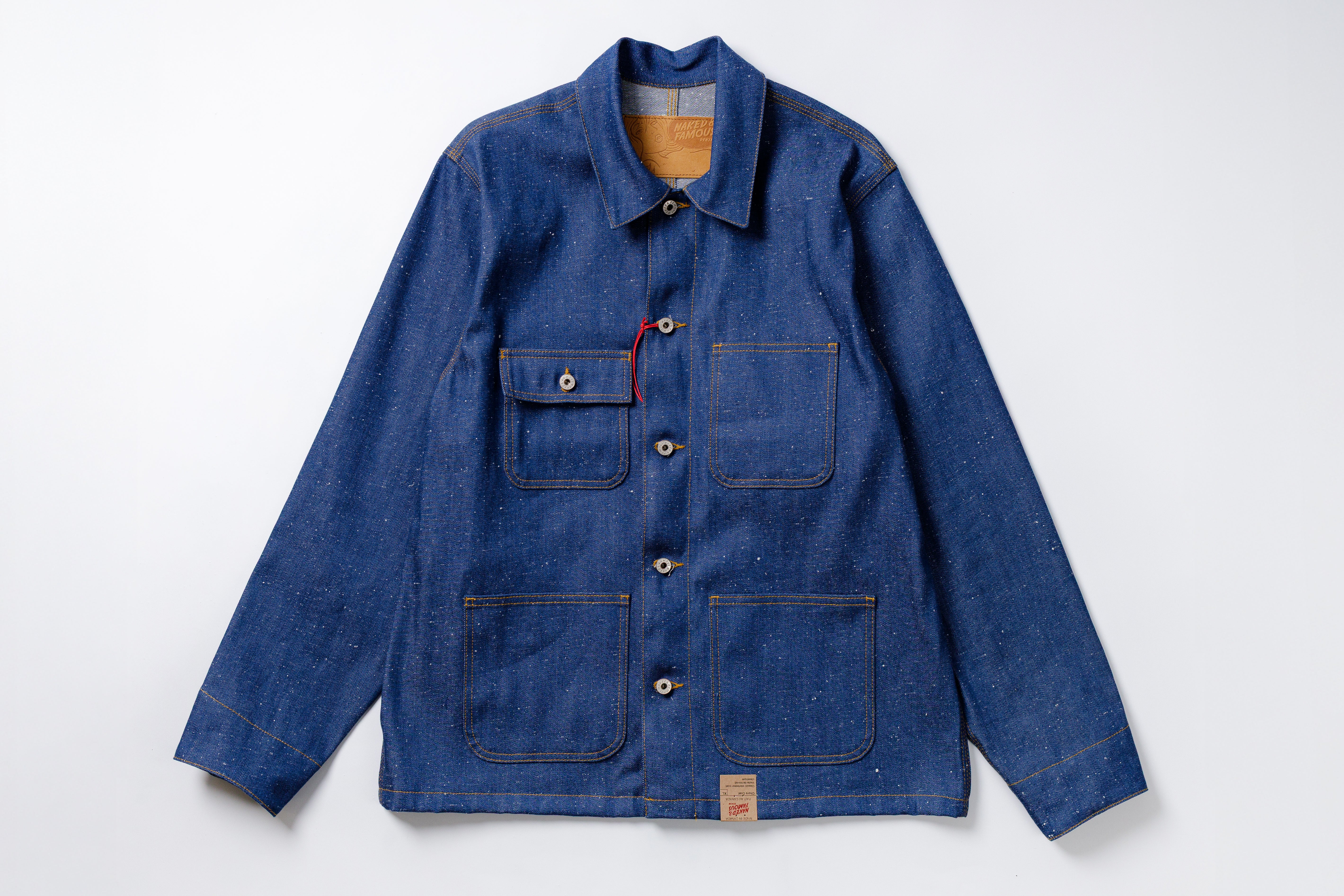 Blue denim jacket with multiple pockets on a white background