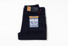 A pair of folded dark indigo denim jeans with a prominent blue, yellow, and white 'MAKAKE DOBBY' patch on the back pocket, shown on a clean white background.