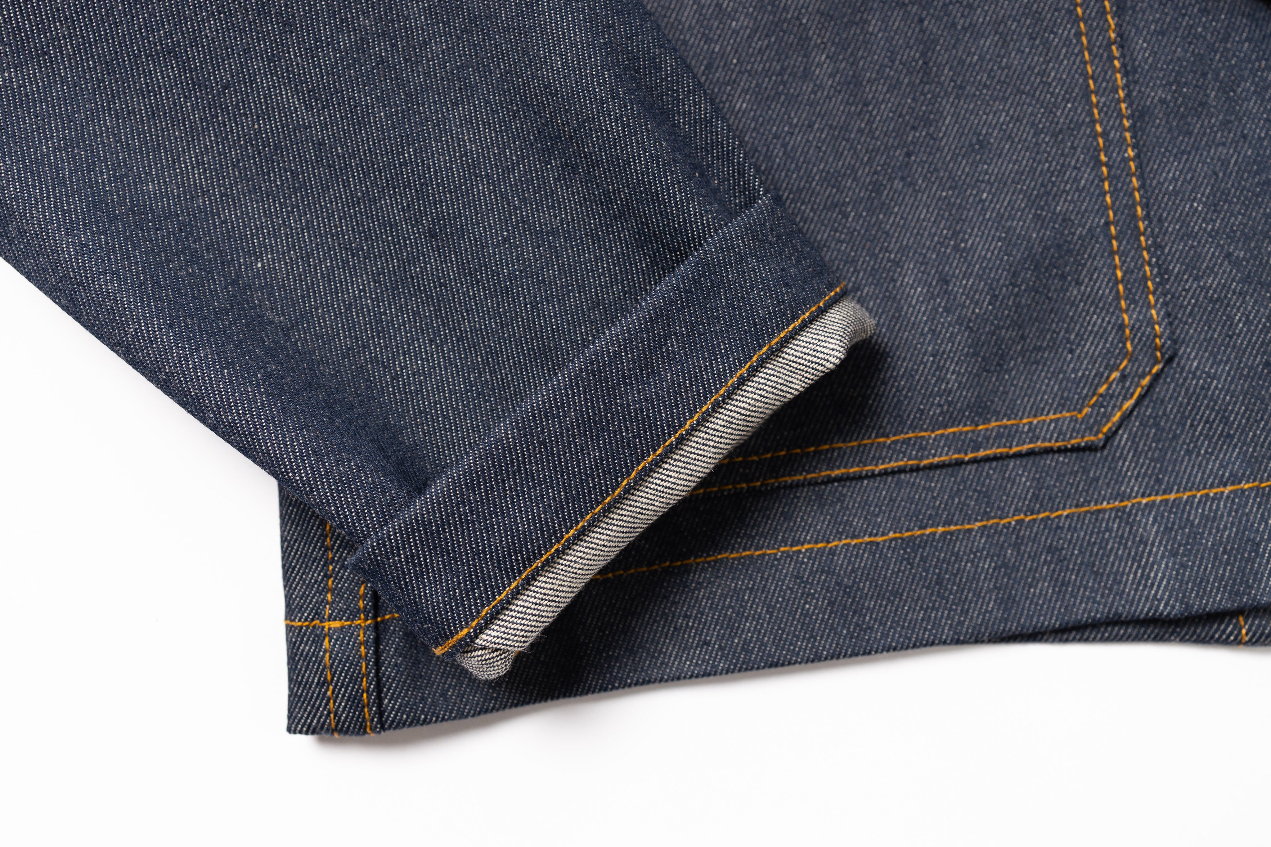 Close-up of blue denim fabric with a white background