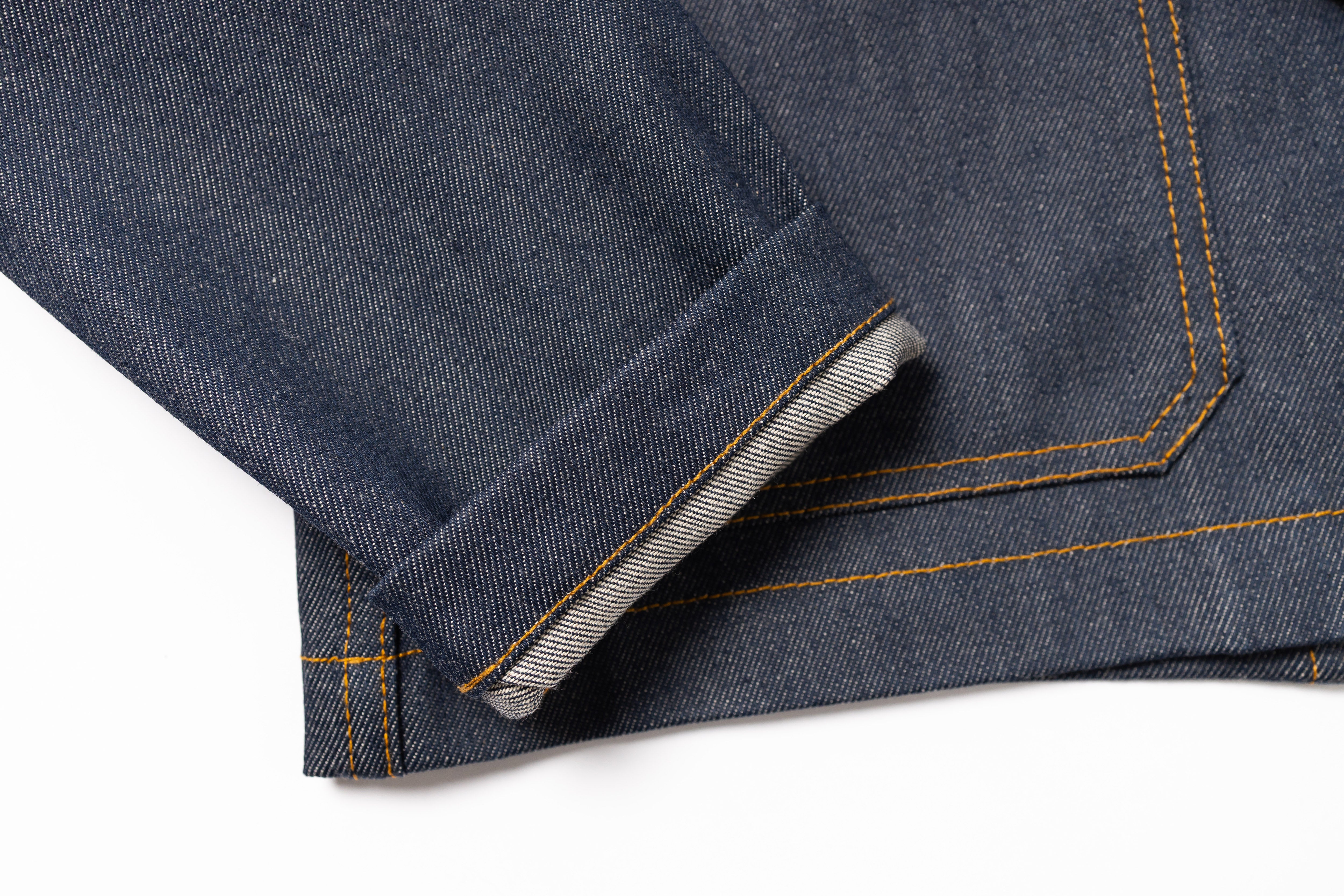 Close-up of blue denim fabric with a white background