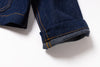 Close-up of rolled-up blue jeans cuff on a white background