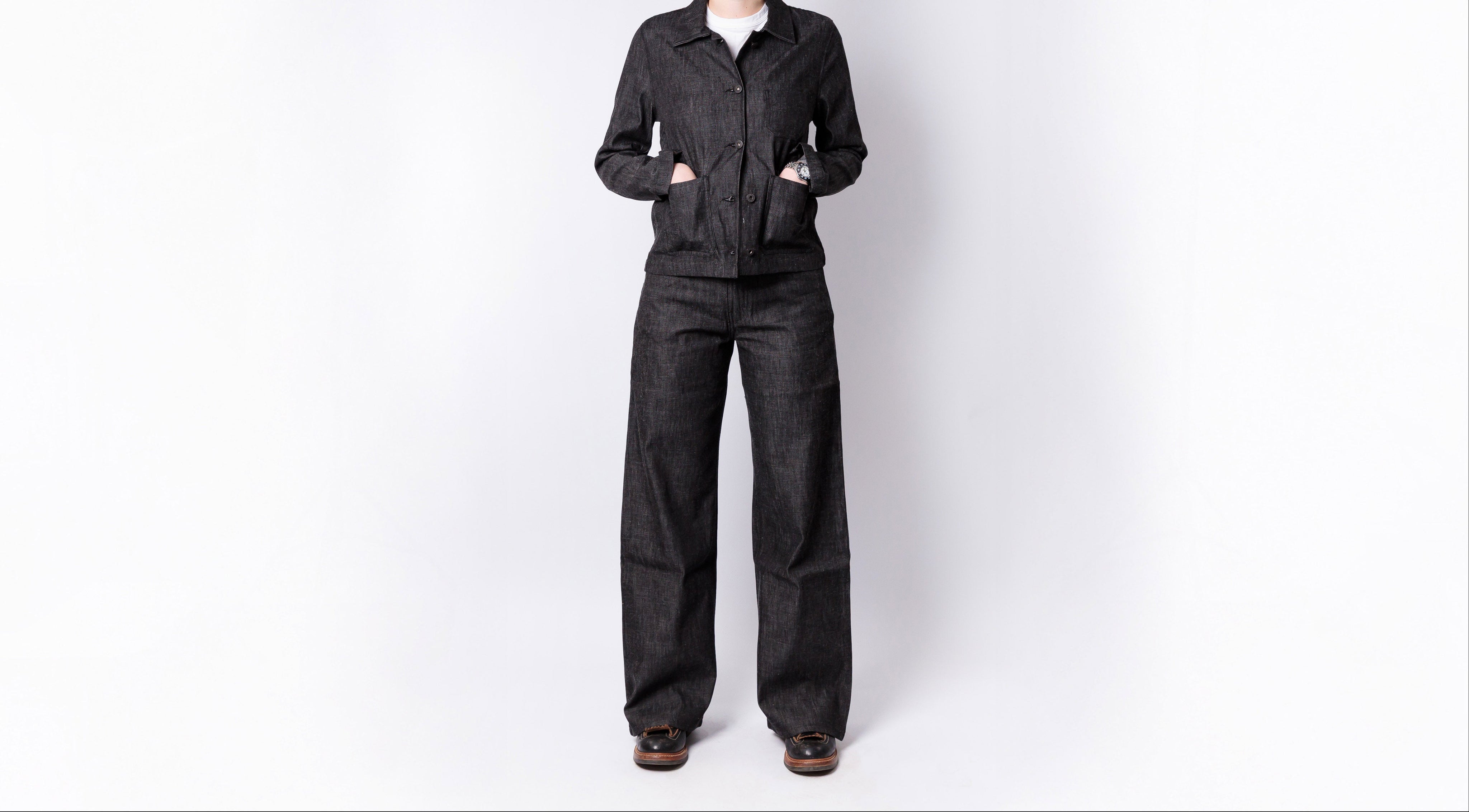 Person wearing a black jumpsuit on a white background