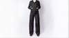 Person wearing a black jumpsuit on a white background