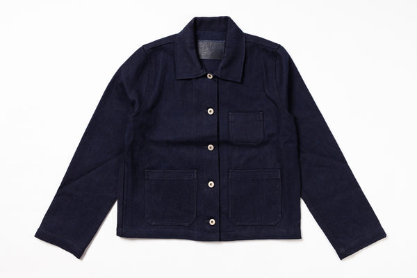 A dark navy blue corduroy utility jacket with a pointed collar, button front, and four front pockets, laid flat on a white background.