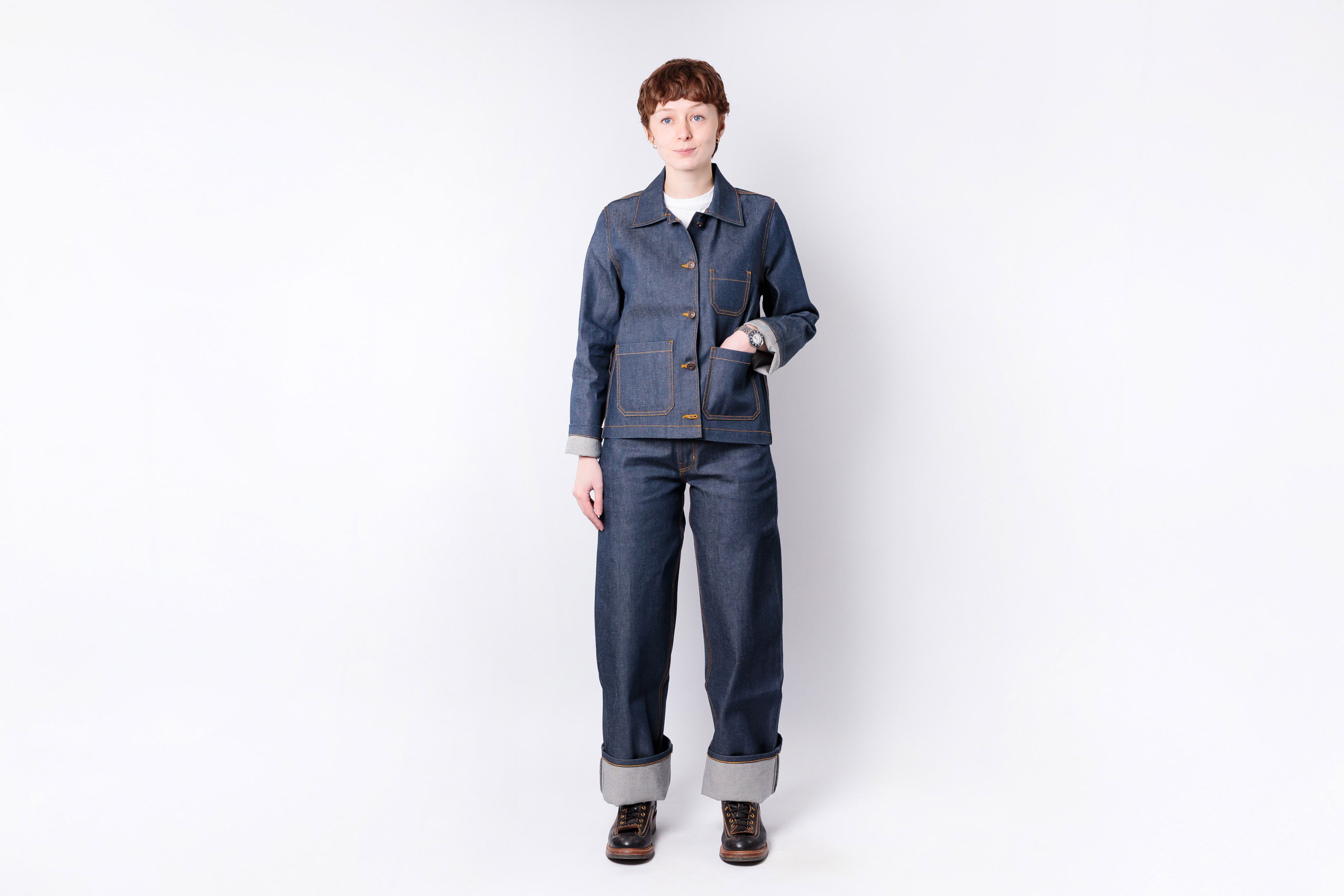Person wearing a blue denim outfit on a white background