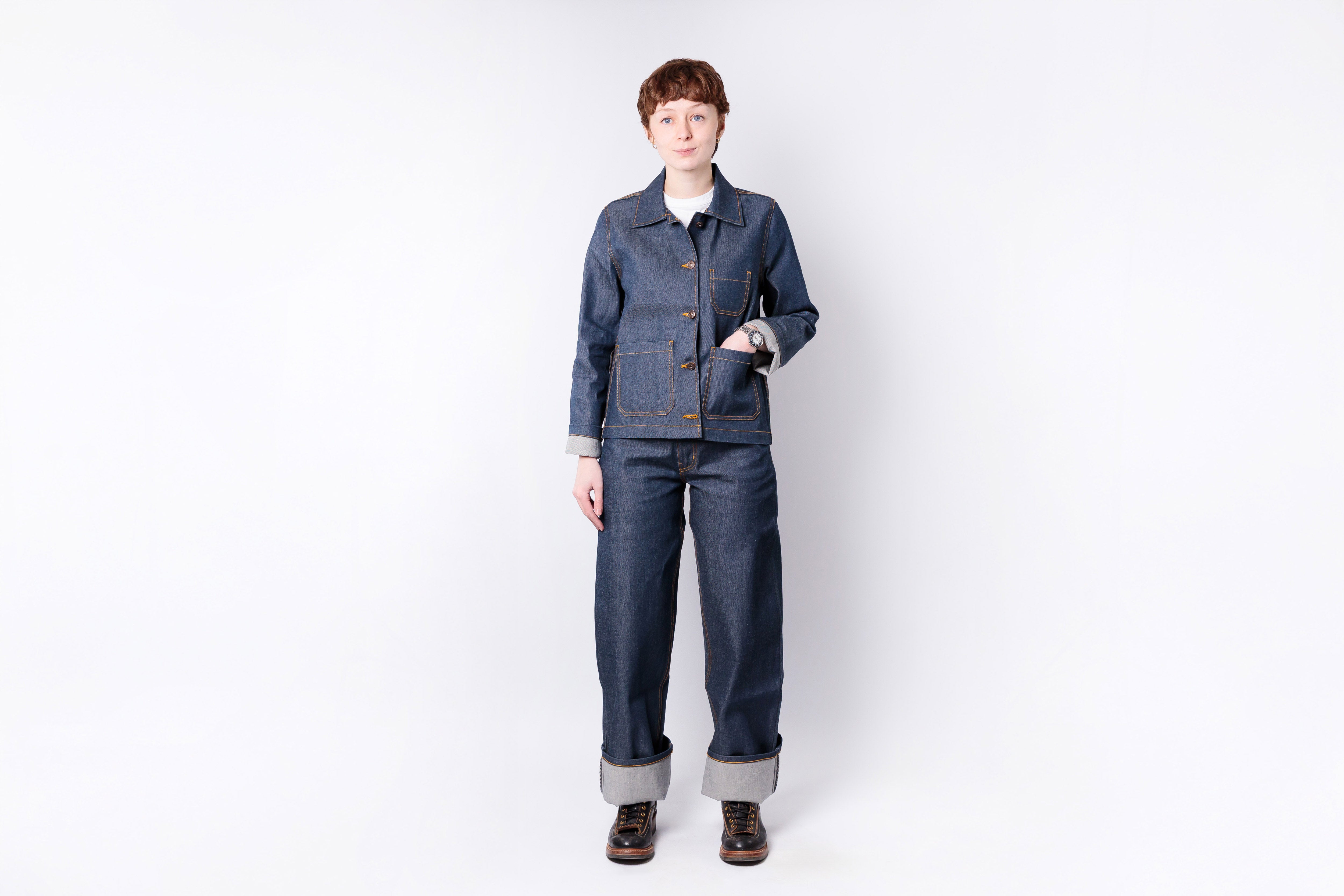 Person wearing a blue denim outfit on a white background