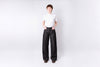 Person wearing a white shirt and dark pants on a white background