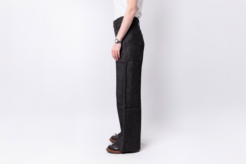 Person wearing dark gray pants on a white background