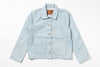 A light blue denim work jacket with a pointed collar, button closure, and four front pockets, laid flat against a white background.