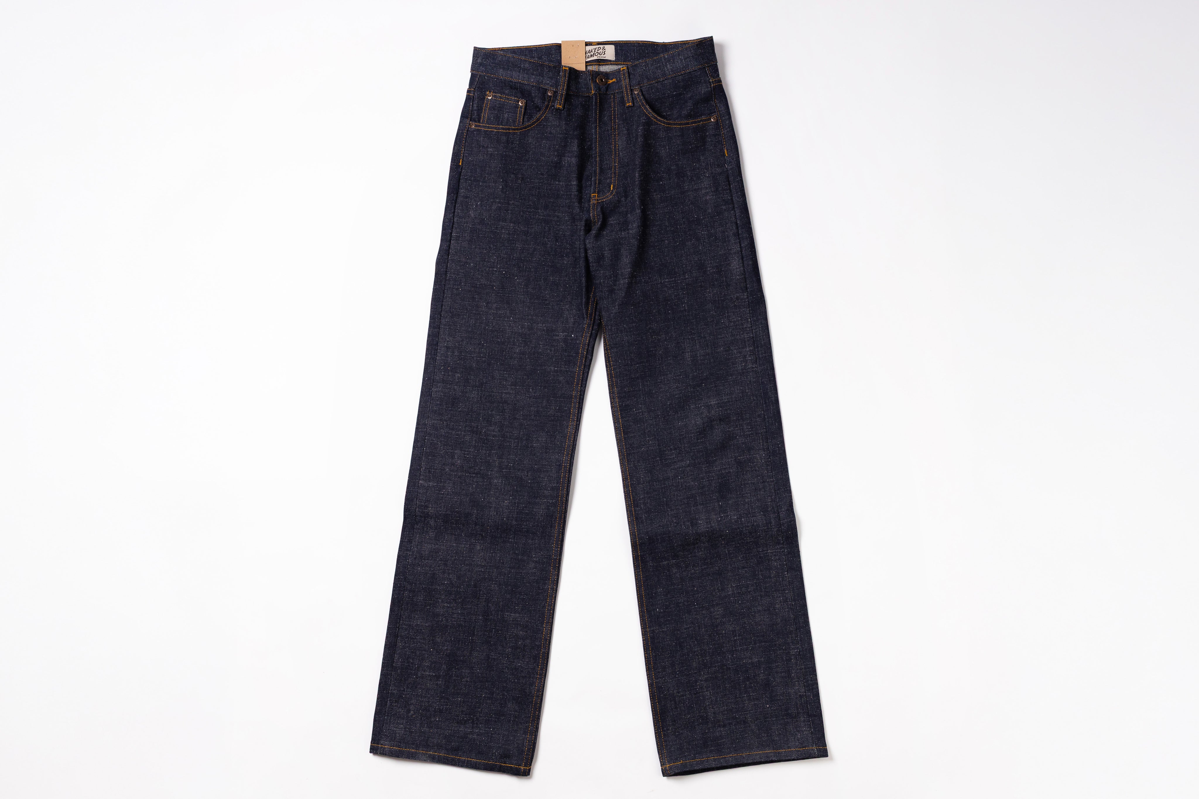 A pair of dark indigo denim jeans laid flat against a clean white background.