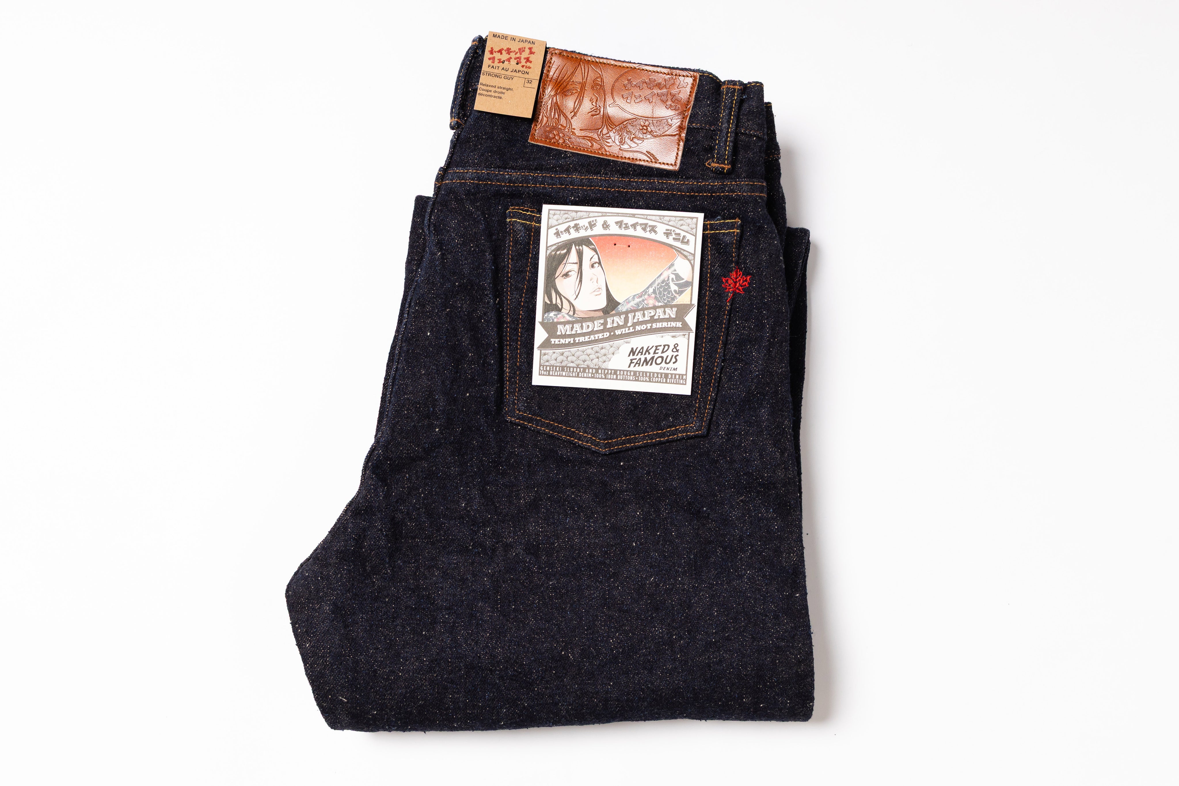Folded pair of dark blue jeans with a brand label on a white background