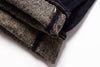 Folded denim jeans on a white background