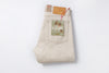 Folded beige jeans with a visible brand label on a white background