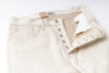 Ecru Jeans with a brand label on a white background