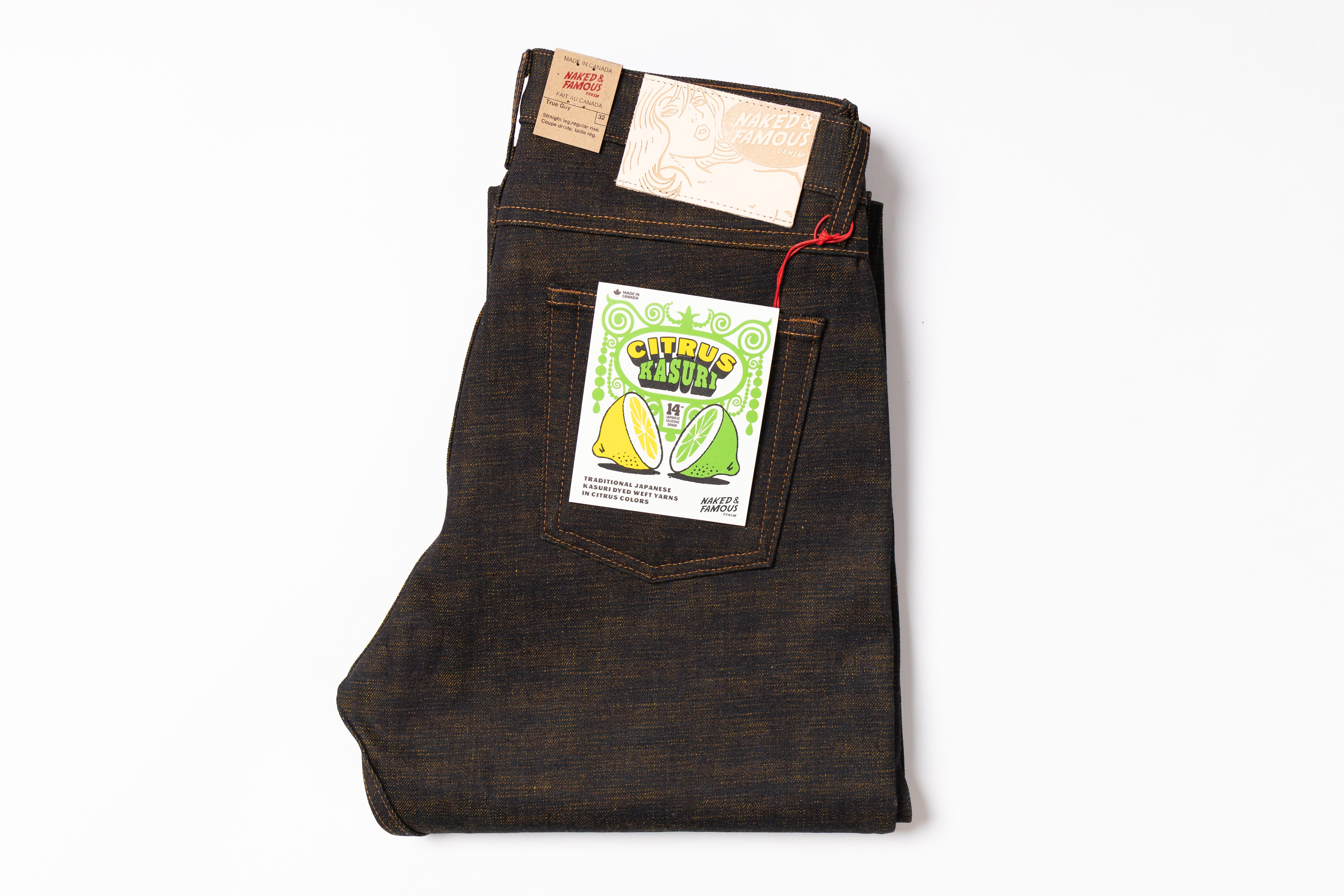 Folded dark denim jeans with a brand label on a white background